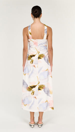 Back view of a model wearing a Pastel Watercolour Cotton Midi Dress with Halter Neck featuring floral patterns.