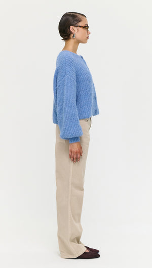 Soft Handle Ballon Sleeve Cardigan in Blue shown on a model, side view showcasing its fluffy texture and casual style.