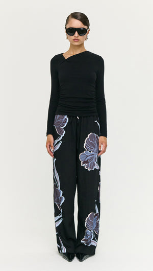 Model wearing Blue Floral Relaxed Drawstring Pant with black top and sunglasses, showcasing a stylish off-duty look.