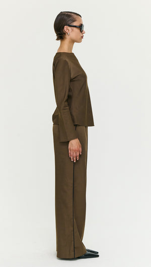 Model wearing an Espresso Bias Cut Boat Neck Top with matching pants, showcasing a minimalist style in earthy tones.