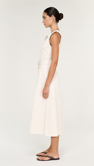 Side view of a model wearing a Cotton Belted Wrap Midi Dress in Cream, showcasing its elegant silhouette.