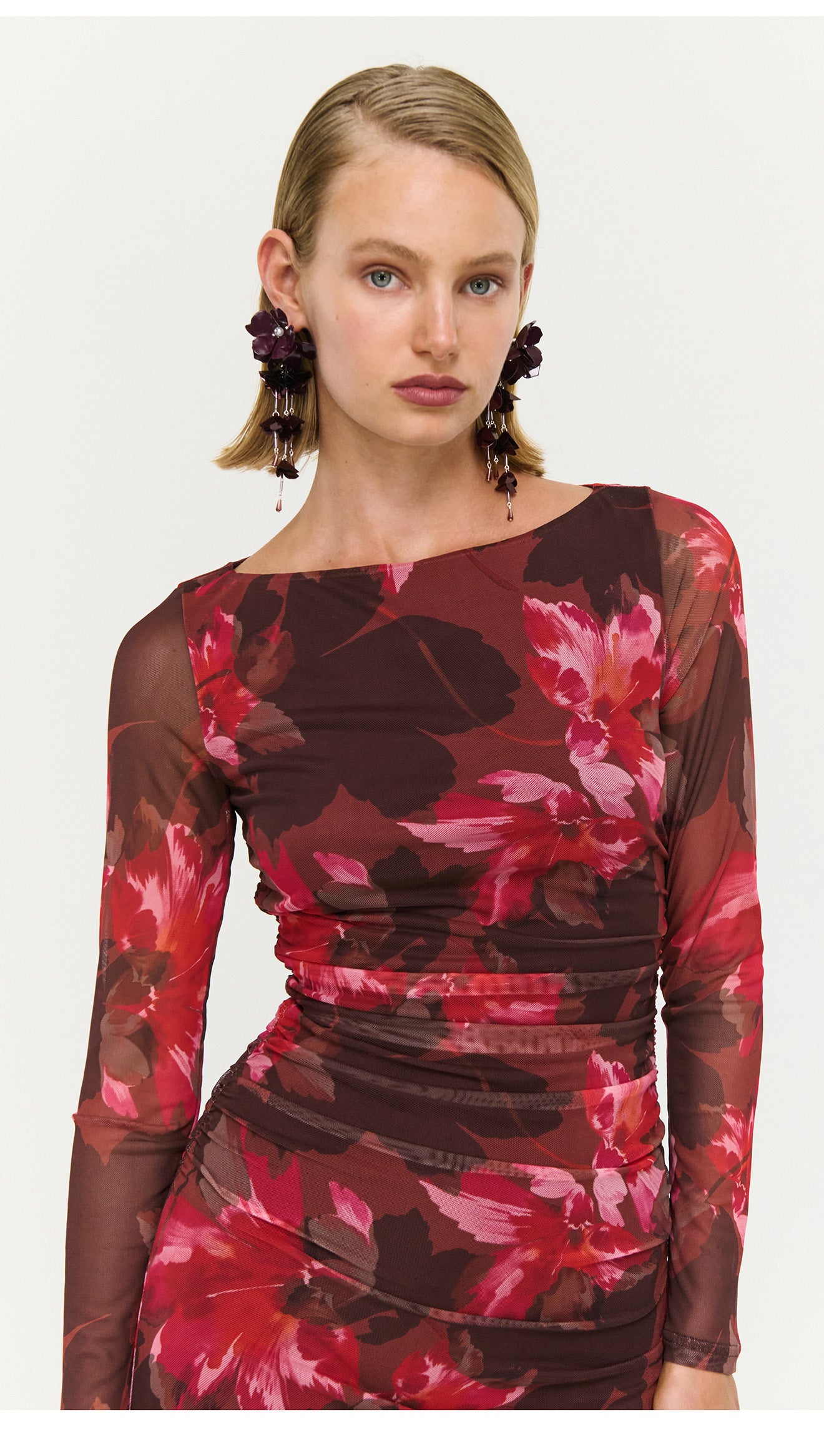 Ruched Pink Floral Mesh Midi Dress worn by a model, showcasing the elegant floral design and flattering silhouette.
