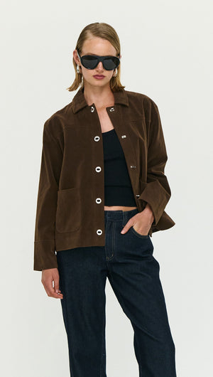 Fashion model wearing a Chocolate Brown Faux Suede Barn Jacket with sunglasses and casual outfit, showcasing modern style.