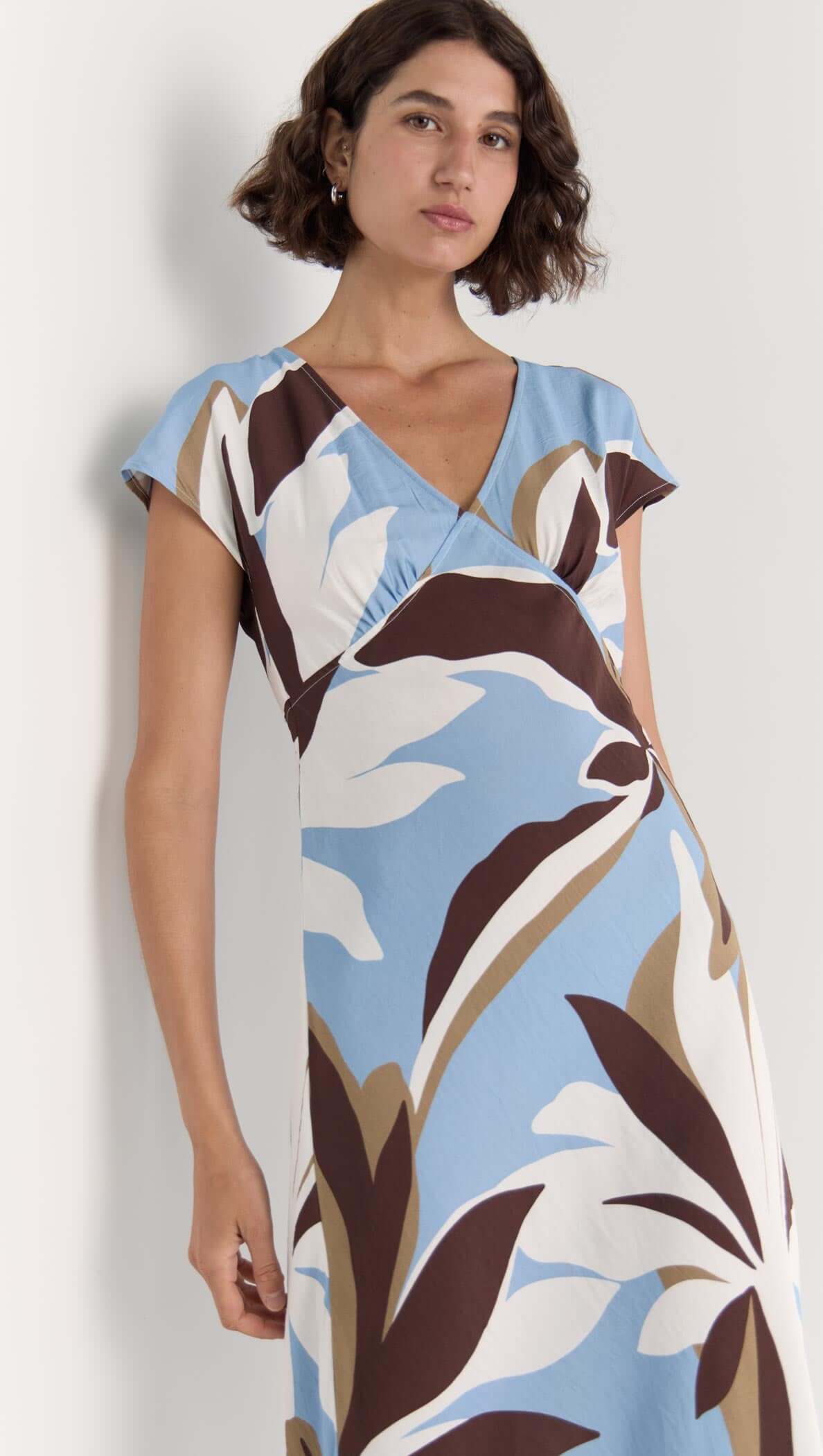 Maeve Midi Dress in brown, cream, and blue abstract floral print with V-neckline and cap sleeves.