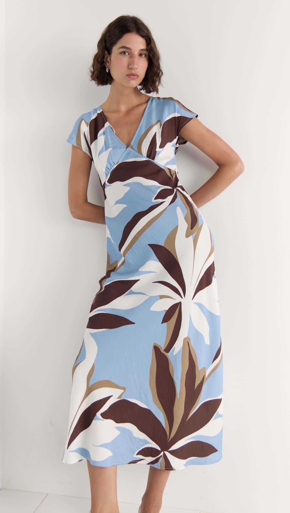Maeve Midi Dress in blue with brown and cream abstract floral print, featuring V-neckline and cap sleeves.