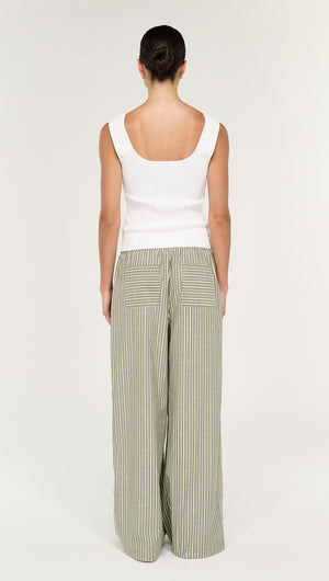 Back view of a model wearing the Khaki Stripe Relaxed Cotton Pant paired with a white top.