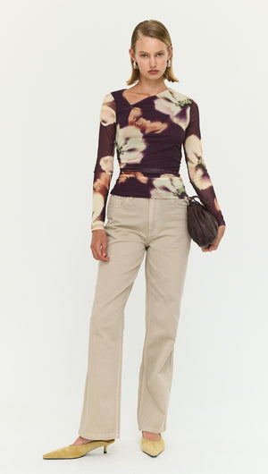 Model wearing a floral long sleeve top with beige Stone Wash Straight Leg Jeans and stylish heels.