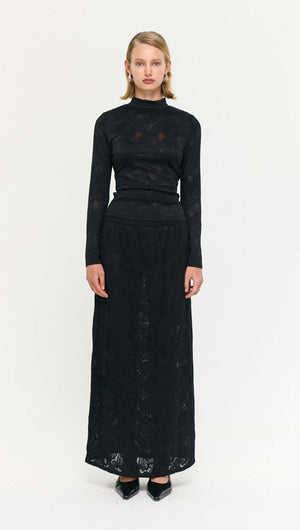 Black Sheer Lace Maxi Skirt worn by a model, showcasing modern style and elegant design.