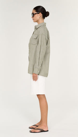 Model wearing a Khaki Stripe Cotton Oversized Shirt, styled with white shorts and flip-flops, showcasing a relaxed fit.