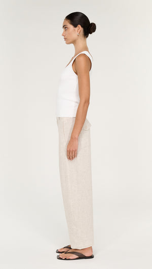 Model showcasing the Viscose Linen Barrel Leg Pant in Oat, styled with a white tank top and sandals.