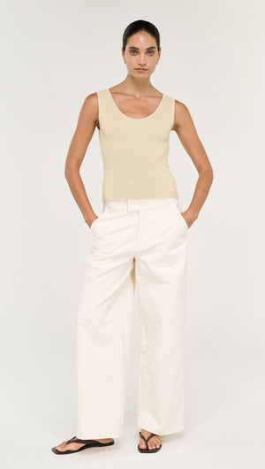 Model wearing Fine Rib Knit Reversible Tank in Ecru with white wide-leg pants and sandals.
