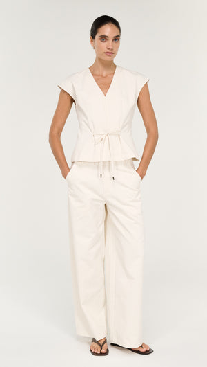 Cotton Tie Front Top with Cap Sleeve styled with wide-leg pants for a chic, modern look.