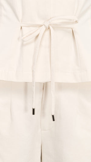 Cotton Tie Front Top with Cap Sleeve featuring a stylish tie detail and elegant cap sleeves.