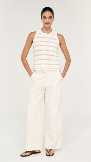 Model wearing a Cotton Blend Stripe Knit Tank in White with wide-legged pants, showcasing a stylish and comfortable summer look.