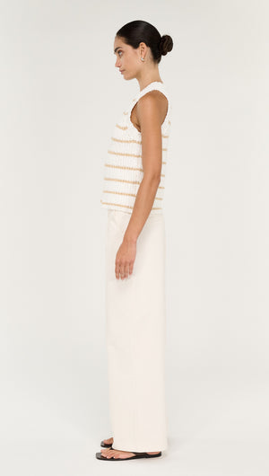 Side view of a model wearing a Cotton Blend Stripe Knit Tank in White paired with light pants.