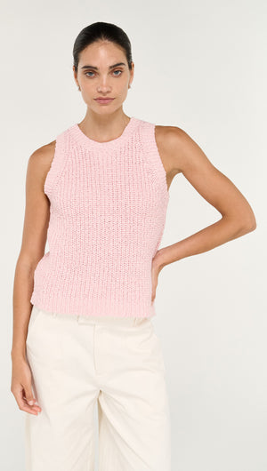 Model wearing a Cotton Blend Knit Tank in Soft Pink paired with white trousers, showcasing a stylish casual look.