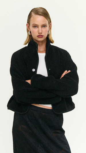 Black High Neck Cropped Sherpa Jacket worn by model, showcasing a cozy and stylish look for cool weather.
