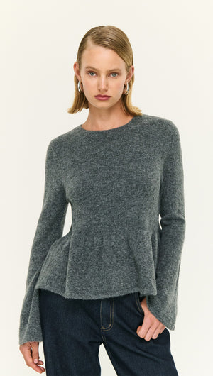 Soft Knit Peplum Top with Flute Sleeve, featuring a soft texture and flared sleeves, ideal for stylish everyday wear.