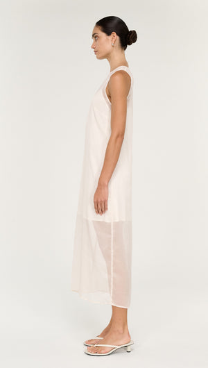 Sheer Layered Slip Midi Dress in Cream displayed on a model from the side, showcasing its translucent fabric and stylish design.