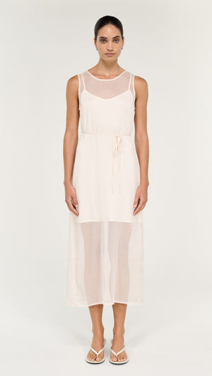 Model wearing Sheer Layered Slip Midi Dress in Cream, featuring a transparent layered design and cinched waist.