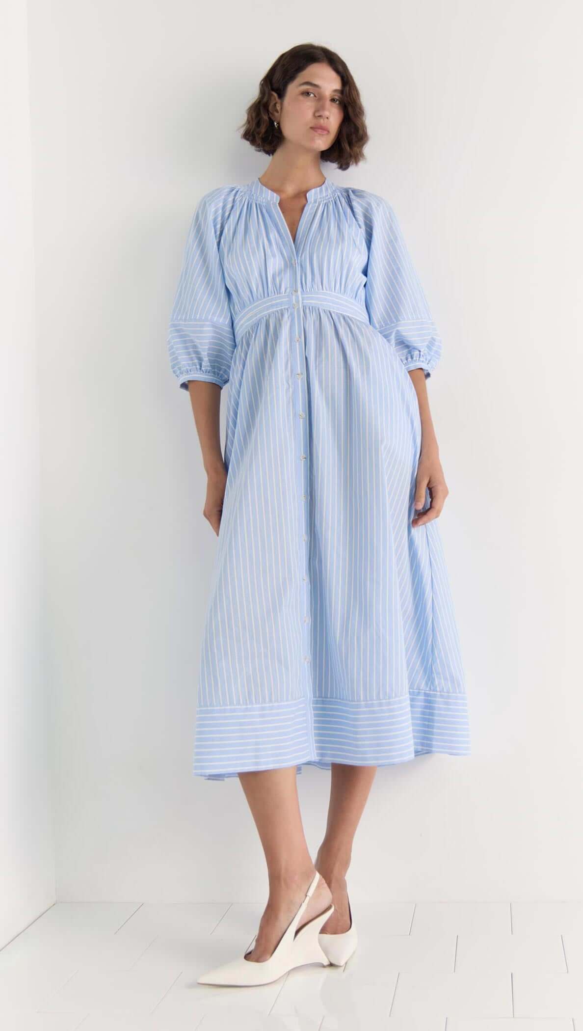 Crisp Myra Midi Dress in soft blue stripes with puff sleeves and a button-down front, perfect for warm weather styling.