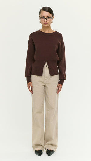 Model wearing a Brown Zip Detail Soft Crew Neck Knit paired with beige high-waisted pants, showcasing modern knitwear style.