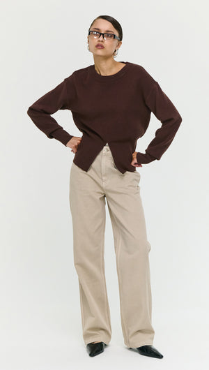 Model wearing a Brown Zip Detail Soft Crew Neck Knit with beige pants, showcasing a modern and stylish look.