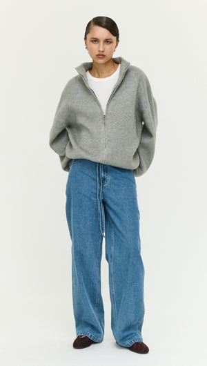 Model wearing Soft Grey Oversized Zip Cardigan paired with blue jeans for a stylish, casual look.