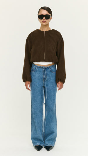Model wearing a Soft Brushed Cropped Bomber Jacket paired with wide-leg jeans and sunglasses, showcasing modern outerwear style.