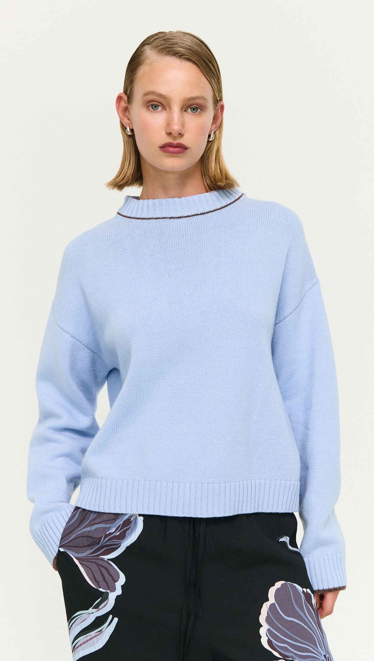 Blue Cotton Blend Contrast Seam Jumper styled with floral print pants on a model.