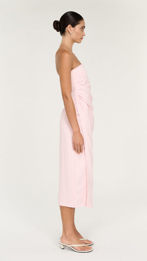 Strapless Wrap Midi Dress in Soft Pink showcased on a model from the side, displaying its elegant design and soft color.
