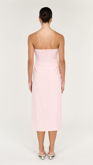 Back view of a model wearing a Strapless Wrap Midi Dress in Soft Pink, showcasing its sleek design and elegant silhouette.