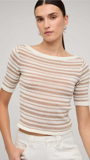 Beige and white striped boat neck knit top featuring short sleeves, styled with white pants.