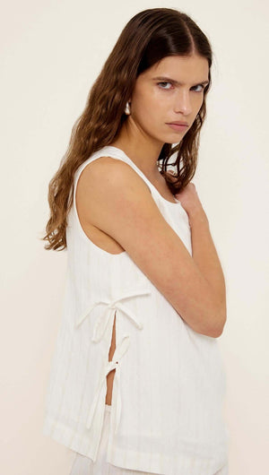 Model wearing a White Tie-Side Top with side ties and a relaxed fit, showcasing a deep V-back design.