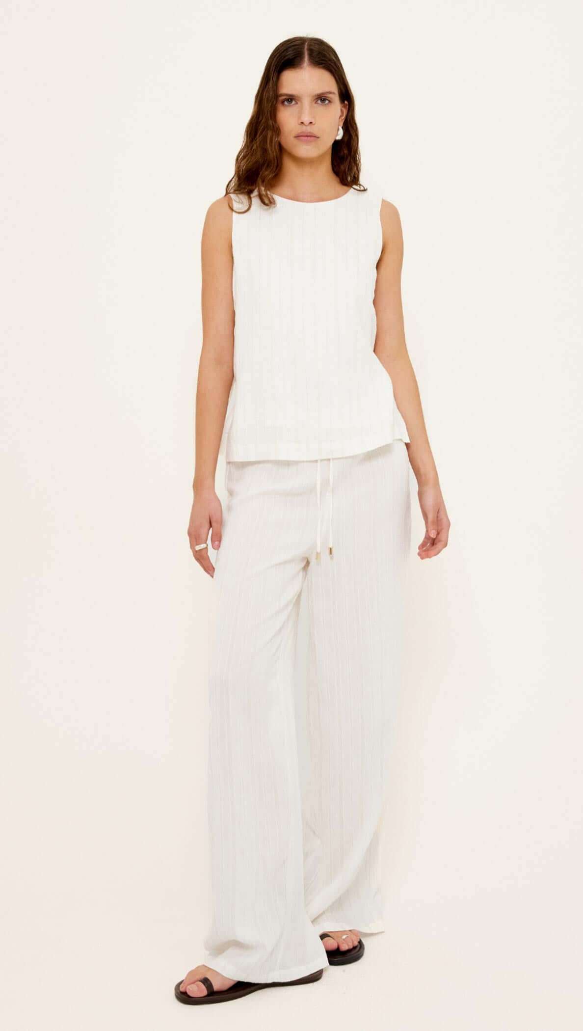 Model wearing a White Tie-Side Top paired with matching white drawstring pants for a stylish summer look.