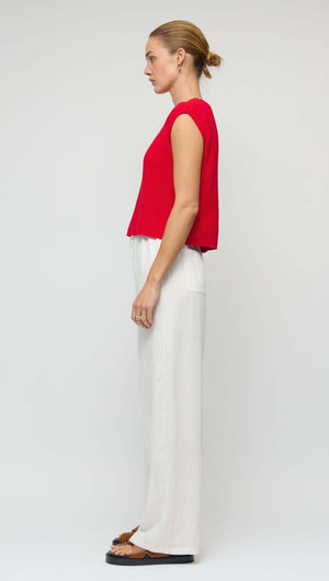 Model wearing White Wide Leg Drawstring Pants paired with a red top, showcasing a relaxed, stylish side view.