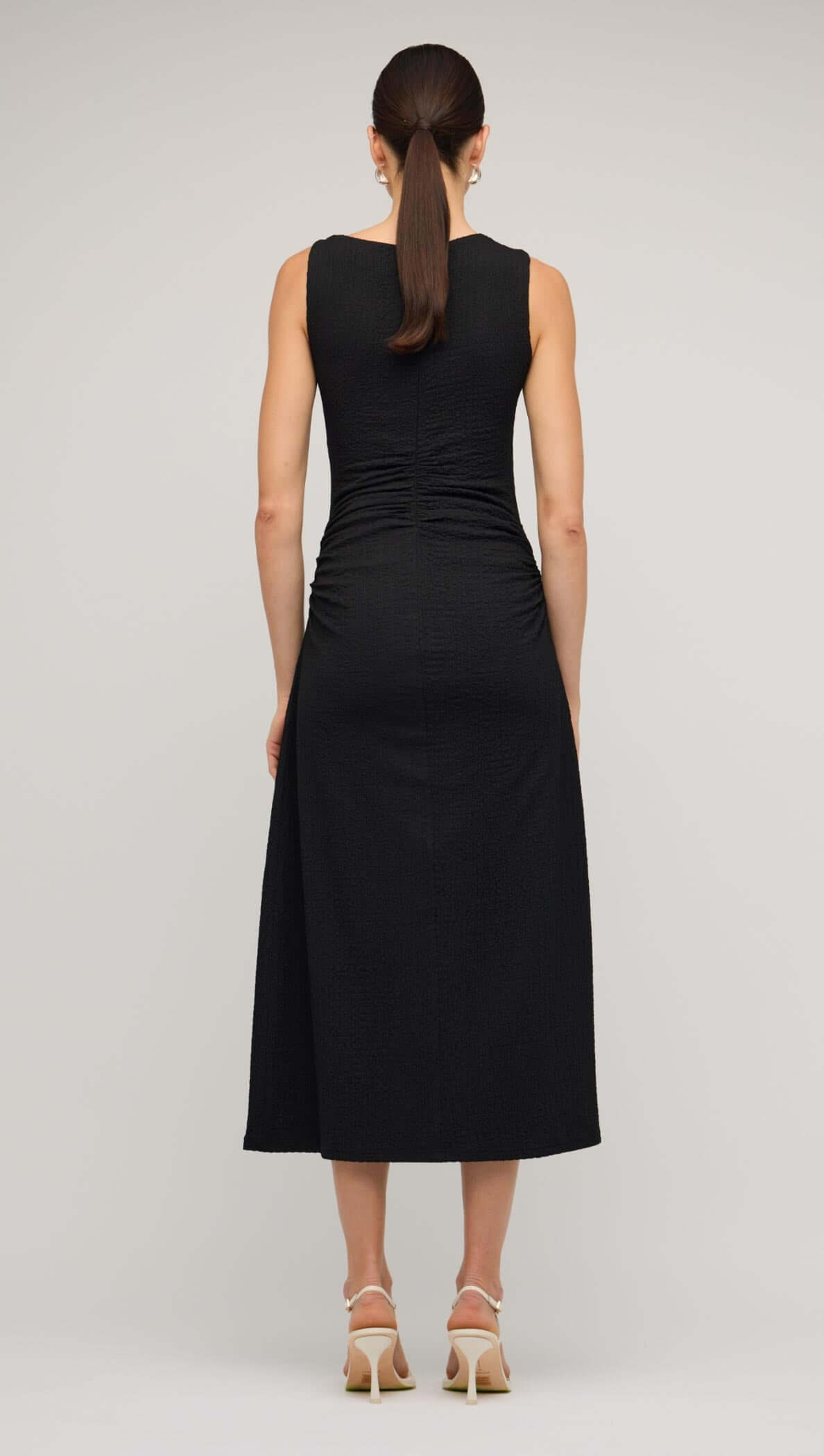 Back view of a Black Cut Out Ruched A-Line Midi Dress showcasing bead detail and sleek fit.