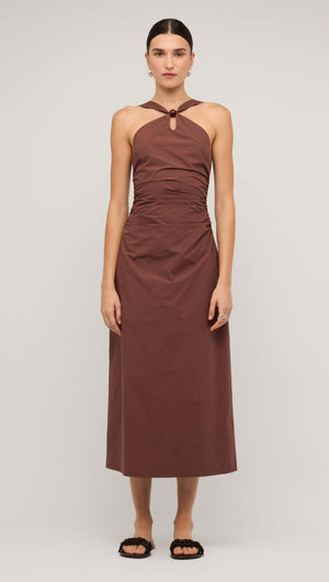 Model wearing a brown cotton bead halter-neck ruched midi dress, showcasing its elegant design.