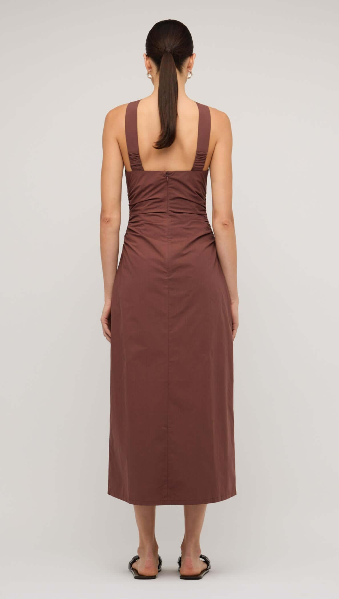 Back view of a brown cotton bead halter-neck ruched midi dress, showcasing its sleek design and elegant fit.