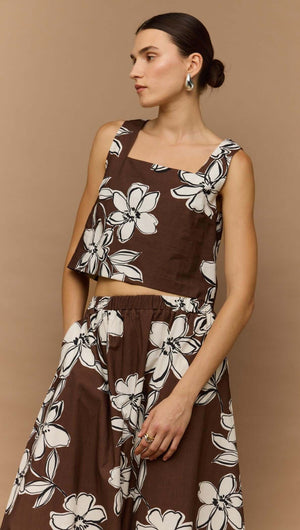 Brown and white floral crop top styled with a matching skirt, showcasing a trendy and versatile summer look.