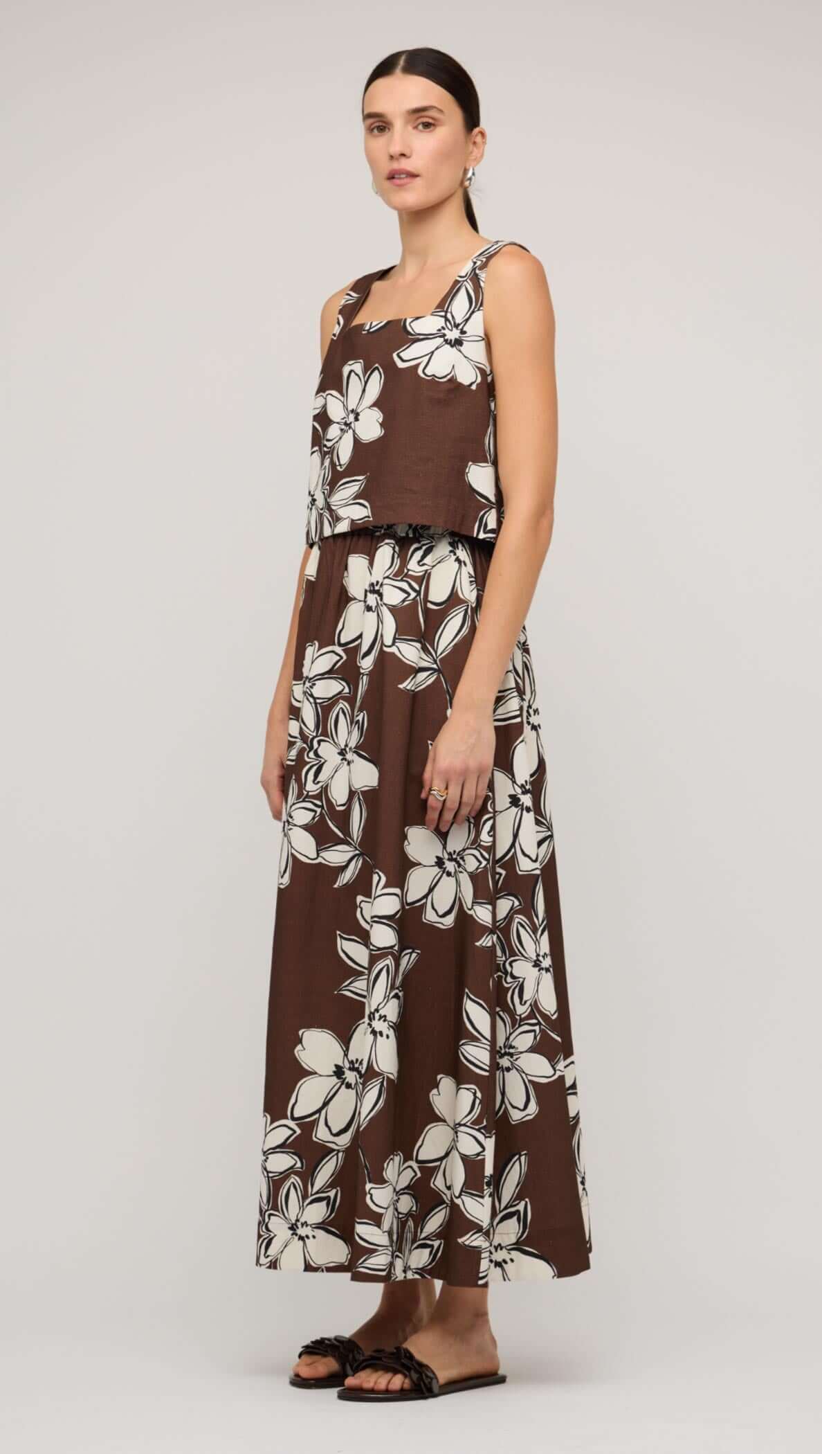Brown and white floral crop top paired with a matching long skirt, showcasing a stylish summer look.