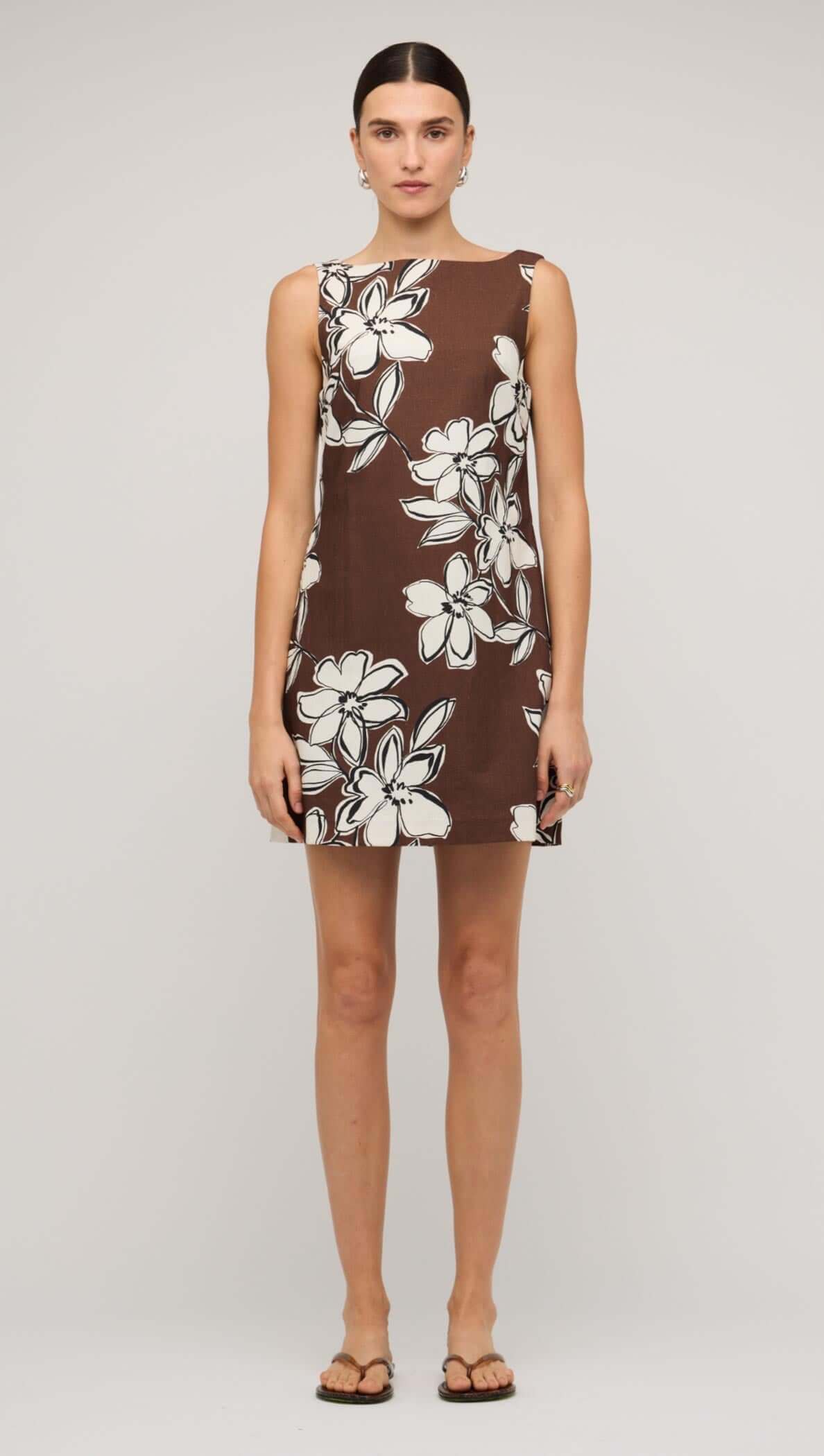 Brown and white cotton floral shift mini dress on a model, showcasing a playful yet polished summer style.