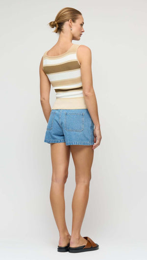 Model showcasing the Reversible Stripe Knit Tank with a scoop back, paired with denim shorts, highlighting warm-weather style.