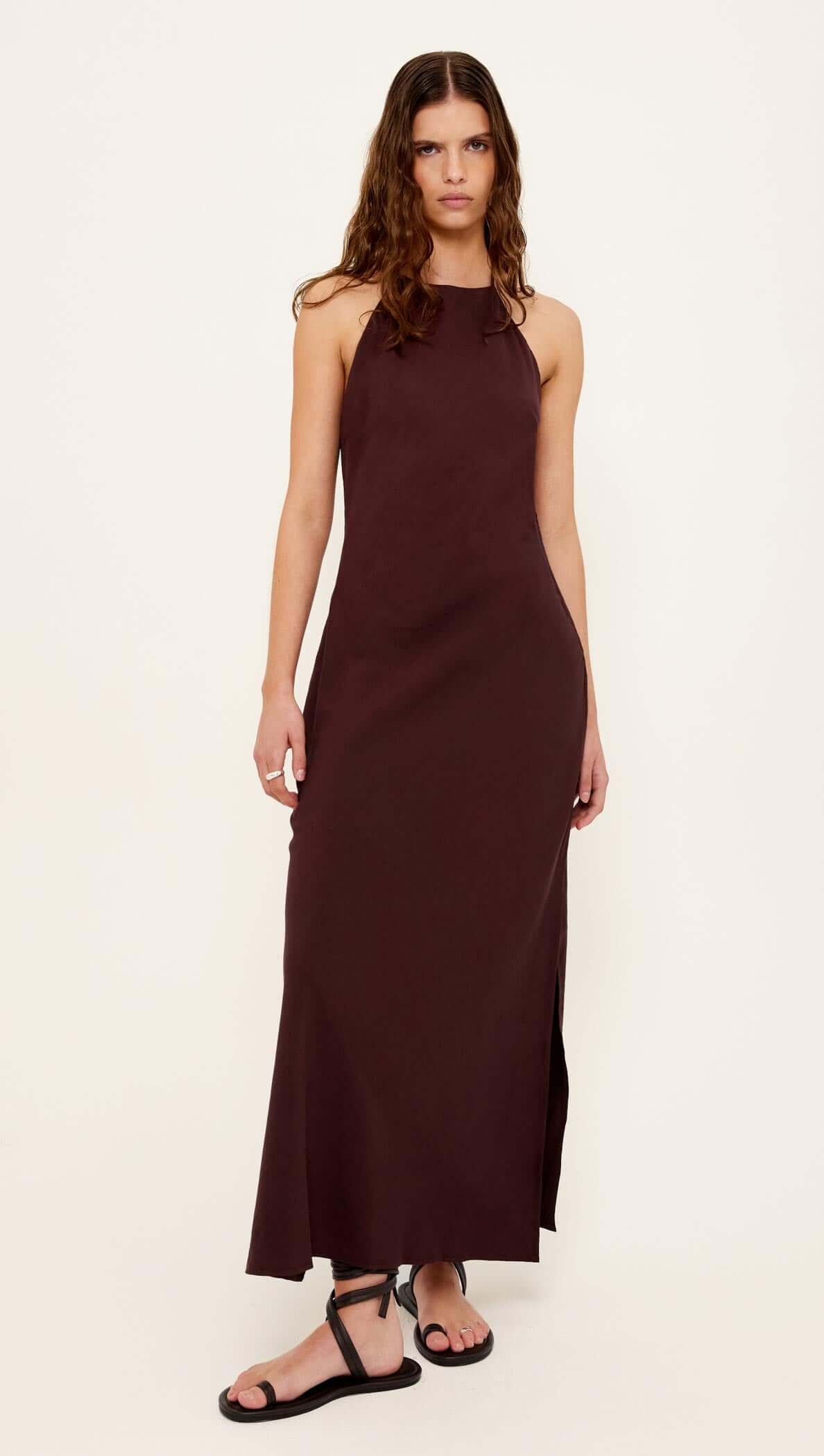 Model wearing the Chocolate Halter Midi Dress featuring a halter neckline and side split.
