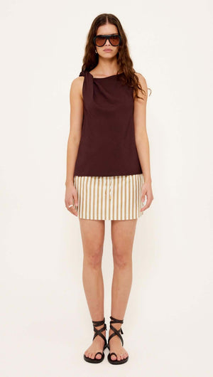 Model wearing Chocolate Twist Top paired with striped skirt and stylish sandals for a chic summer look.