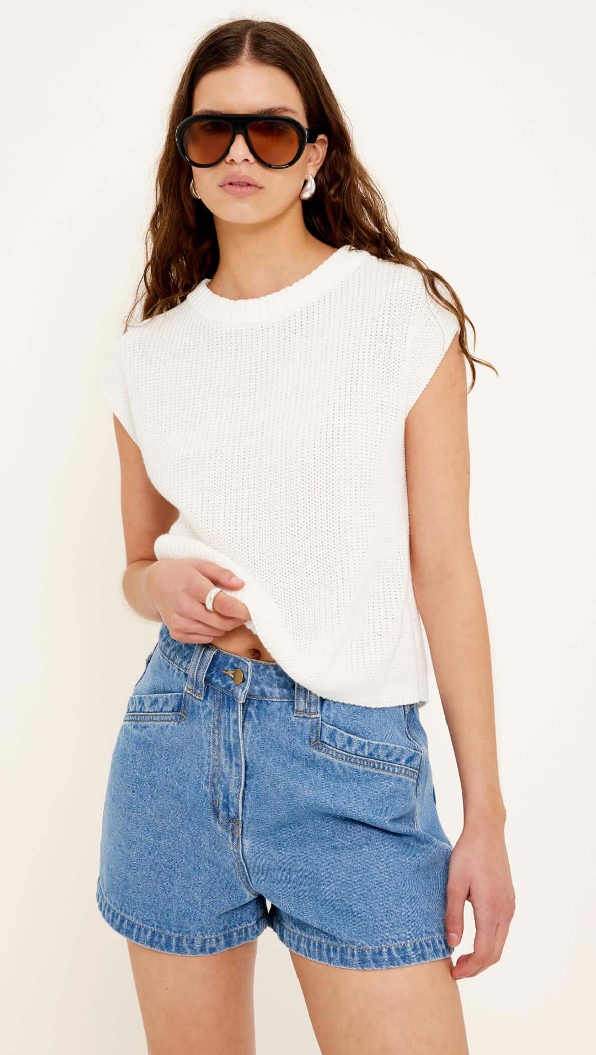Cotton Blend White Knit Tank Top worn by a model, showcasing a relaxed fit and modern silhouette.