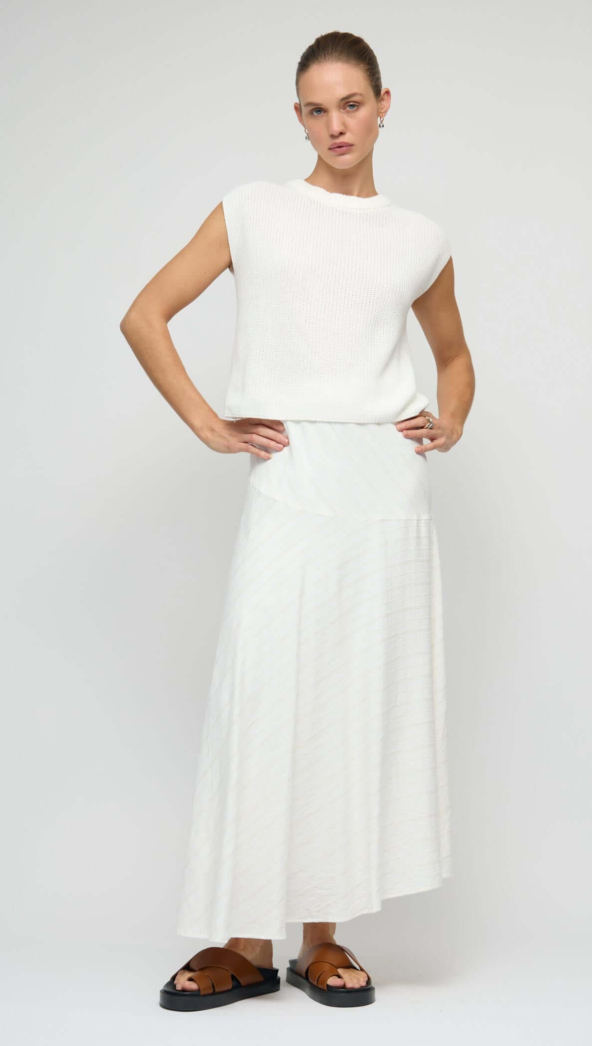 Cotton Blend White Knit Tank Top worn with a matching white skirt, featuring a relaxed fit and modern silhouette.
