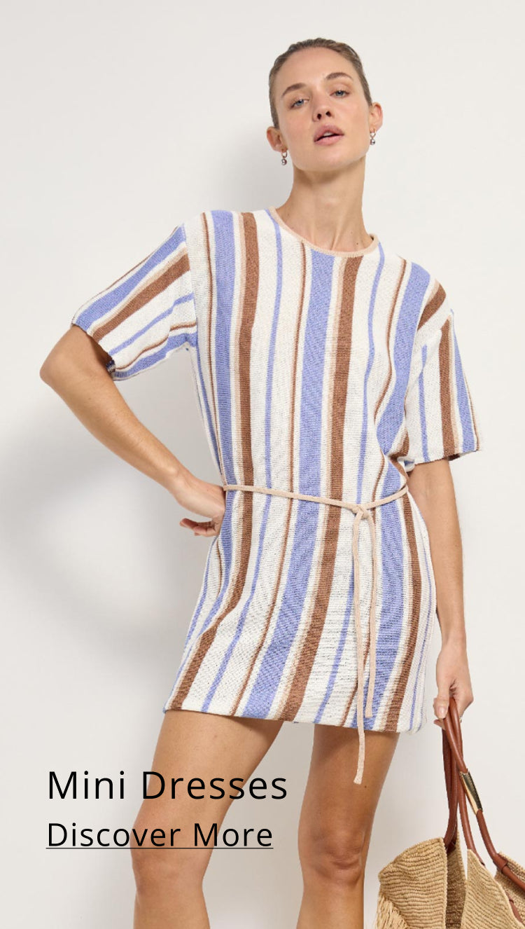 Woman wearing a striped mini dress with text 'Mini Dresses Discover More' on a white background
