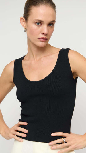 Model wearing a stylish Reversible Black Knit Tank Top with a scoop neckline, showcasing its fitted silhouette.