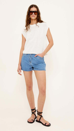 Model wearing NOA DENIM SHORTS styled with a white top and black sandals, showcasing a casual summer look.